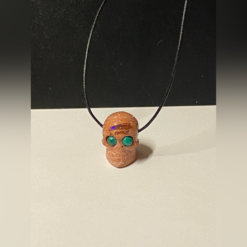 Handcarved, Mexican Opal aliens skull pendant on cord